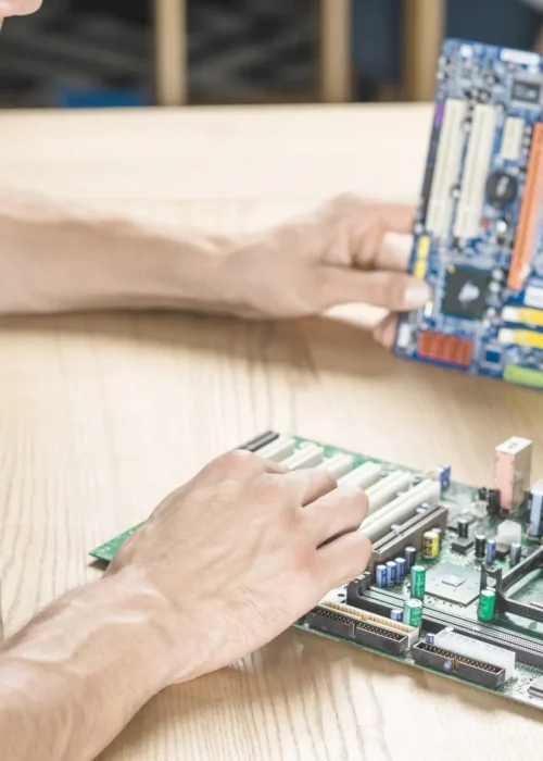 it-technician-upgrading-motherboard-wooden-table it-technician-upgrading-motherboard-wooden-table