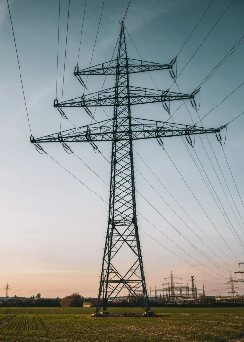 Vertical shot of an electric pole under a blue cloudy sky A vertical shot of an electric pole under a blue cloudy sky